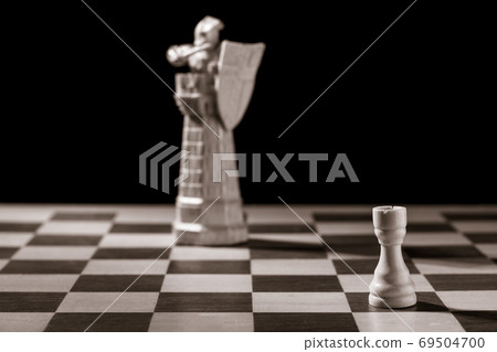 Classic white rook and the same chess piece in the form of medieval figure Classic white rook and the same chess piece in the form of medieval figure 69504700