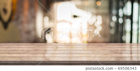 Empty wooden table top with lights bokeh on blur restaurant background Empty wooden table top with lights bokeh on blur restaurant background 69506343