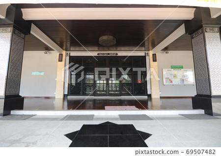 KELANTAN, MALAYSIA -MARCH 30, 2014: Bunut Payung Mosque. New mosque build with local architectural style with influenced of Islamic geometry and Islamic architectural element. KELANTAN, MALAYSIA -MARCH 30, 2014: Bunut Payung Mosque. New mosque build with local architectural style with influenced of Islamic geometry and Islamic architectural element. 69507482