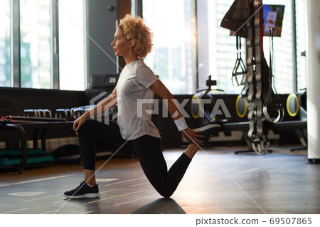 Woman exercising in gym Woman exercising in gym 69507865