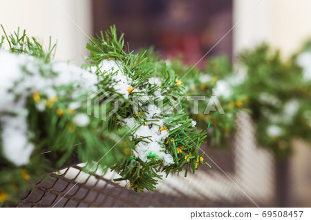 Christmas decor railing branches of a blue Christmas tree. Decoration outside the house to create a festive atmosphere Christmas decor railing branches of a blue Christmas tree. Decoration outside the house to create a festive atmosphere 69508457