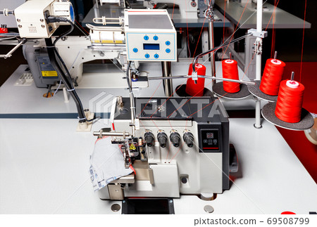 Professional sewing machine overlock, equipment for sewing various fabrics and clothes, close-up. 69508799