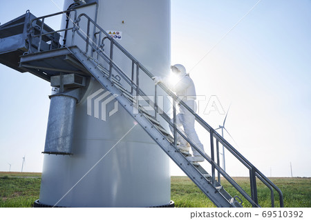 Astronaut going up the rocket stairs 69510392