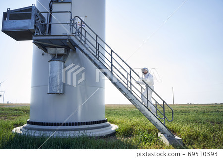 Astronaut in space suit climbing the rocket stairs 69510393