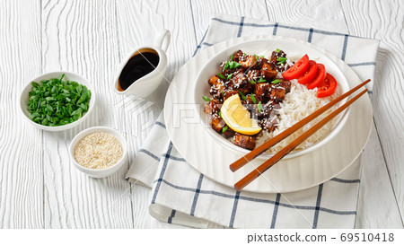 Teriyaki baked tofu with rice on a white bowl 69510418