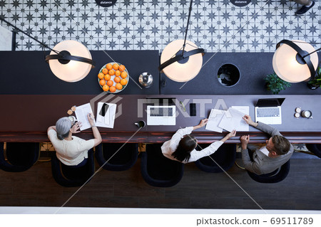 Business negotiations of office workers while making decide in the coworking space 69511789