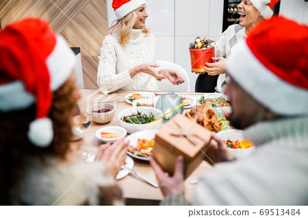 Smiling men giving gifts to their girlfriends at home 69513484