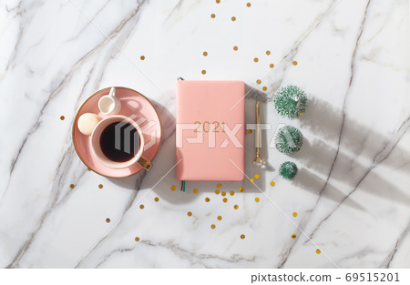 Flat lay composition with New Year's decoration, coral colored 2021 diary book and coffee cup 69515201