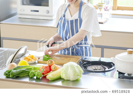 Woman cutting vegetables without face 69518928