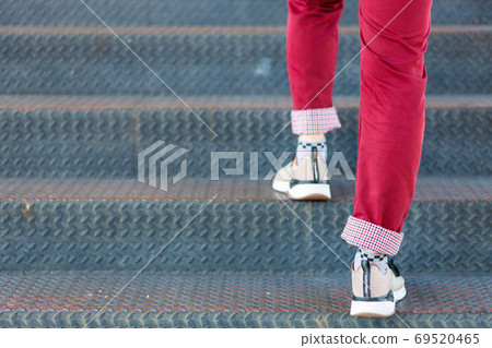 Close-up of man's shoes walking upstairs 69520465