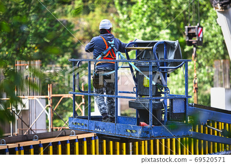 Man working on freight elevators on a construction site 69520571