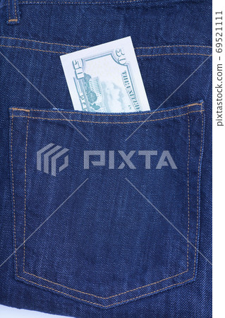 Fifty dollar bills sticking out of the pocket of denim jeans Fifty dollar bills sticking out of the pocket of denim jeans 69521111