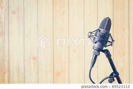 condenser microphone on wooden studio wall background condenser microphone on wooden studio wall background 69521113