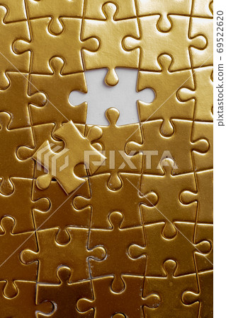 gold puzzles with one piece missing, flat lay. Nobody gold puzzles with one piece missing, flat lay. Nobody 69522620