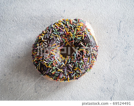 A sweet donut with a chocolate coating. A sweet donut with a chocolate coating. 69524491