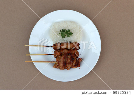 Three Grilled pork skewers with glutinous rice or sticky rice on the white plate 69525584