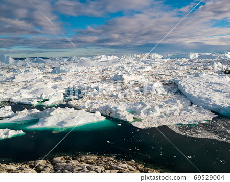 Iceberg and ice from glacier in arctic nature landscape on Greenland 69529004