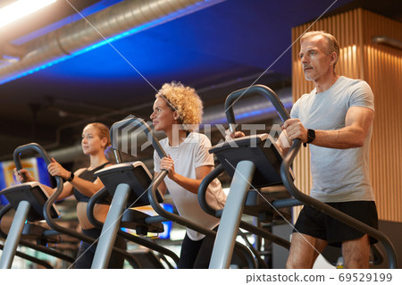 People running on treadmills People running on treadmills 69529199