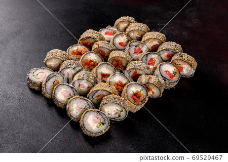 Fresh delicious beautiful sushi rolls on a dark background 69529467