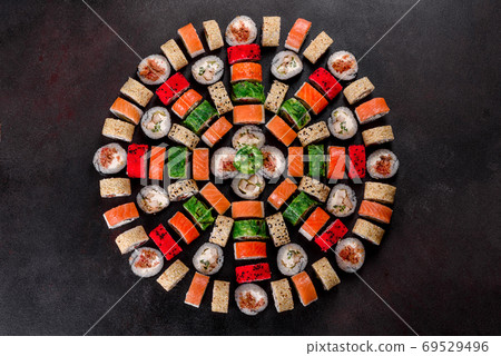 Fresh delicious beautiful sushi rolls on a dark background Fresh delicious beautiful sushi rolls on a dark background 69529496