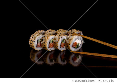Fresh delicious beautiful sushi rolls on a dark background 69529510