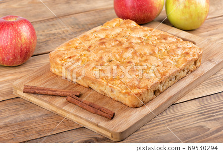 Homemade cinnamon apple pie on a cutting board. Homemade cinnamon apple pie on a cutting board. 69530294