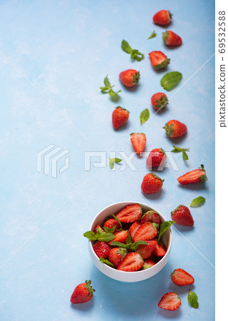 mint and ripe strawberries in a white bowl mint and ripe strawberries in a white bowl 69532588