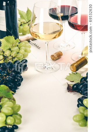 Glasses of white, red and rose wine and grapes Glasses of white, red and rose wine and grapes 69532630