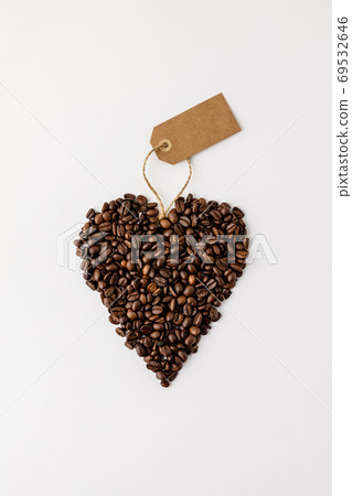 Coffee beans in shape of heart on white background, flat lay 69532646