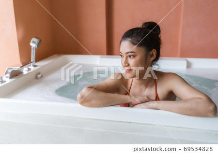 woman in bikini relaxing inside bathtub 69534828