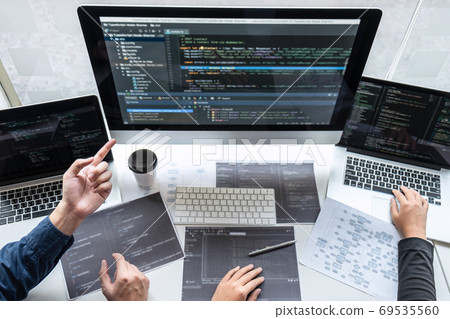 Team of developer programmer working on project in 69535560