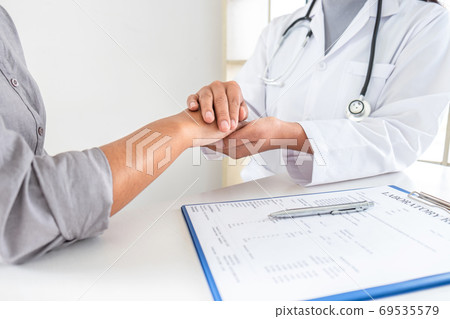 Hand of doctor touching patient reassuring for 69535579