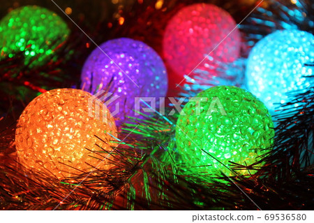 Christmas balls with light. Christmas evening background. Christmas balls with light. Christmas evening background. 69536580
