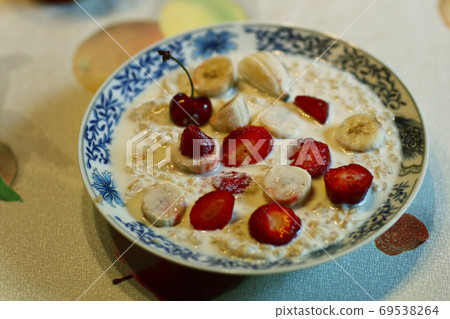 healthy breakfast - porridge with fruit strawberry, banana and cherry 69538264