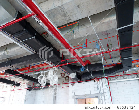 KUALA LUMPUR, MALAYSIA - AUGUST 31, 2019: Air-condition and ventilation duct under construction at the construction site. Distributing cool air and control the room's temperature. KUALA LUMPUR, MALAYSIA - AUGUST 31, 2019: Air-condition and ventilation duct under construction at the construction site. Distributing cool air and control the room's temperature. 69538424