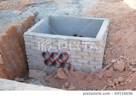 SEREMBAN, MALAYSIA -AUGUST 5, 2020: Utility services manhole and underground pipes under construction at the construction site. In-situ construction by workers based on infrastructure engineer design. 69538696