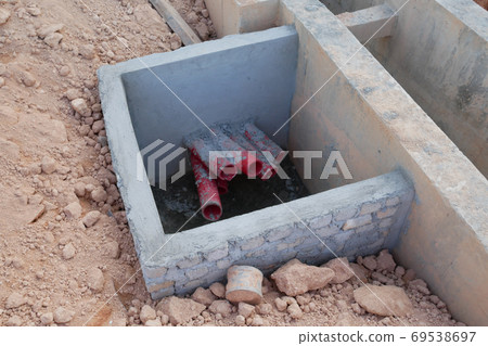 SEREMBAN, MALAYSIA -AUGUST 5, 2020: Utility services manhole and underground pipes under construction at the construction site. In-situ construction by workers based on infrastructure engineer design. 69538697