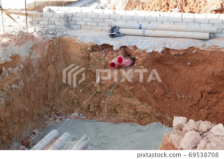 SEREMBAN, MALAYSIA -AUGUST 5, 2020: Utility services manhole and underground pipes under construction at the construction site. In-situ construction by workers based on infrastructure engineer design. 69538708