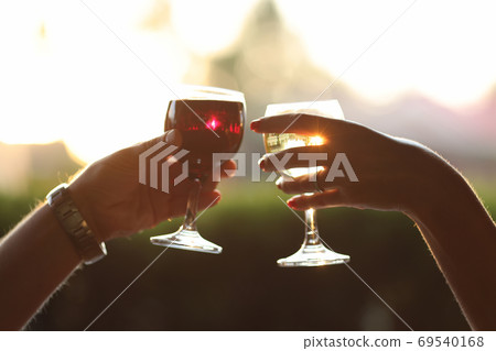 Romantic evening with glass of vine at sunset. Romantic evening with glass of vine at sunset. 69540168