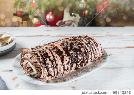 Belgian Chocolate Meringue Roulade filled with whipped cream and Belgian Chocolate Meringue Roulade filled with whipped cream and 69540248