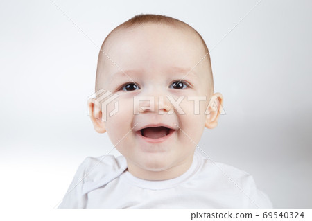 Portrait of a ten-month-old smiling baby on a white background 69540324