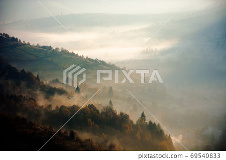 foggy mountain landscape at sunrise. beautiful autumn scenery in foggy mountain landscape at sunrise. beautiful autumn scenery in 69540833