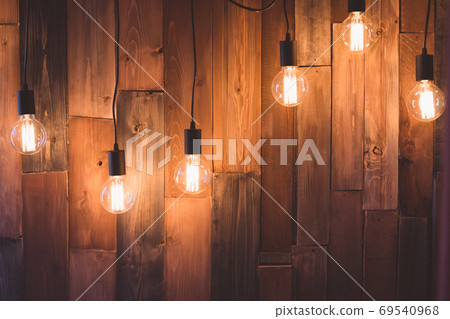 Hanging light bulbs over the wooden background, Hanging light bulbs over the wooden background, 69540968