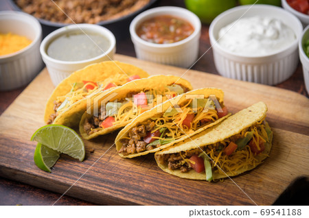 hard shell taco on wooden cutting board hard shell taco on wooden cutting board 69541188