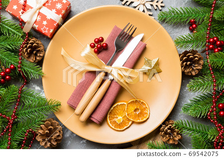Top view of cutlery and plate on festive cement background. New Top view of cutlery and plate on festive cement background. New 69542075
