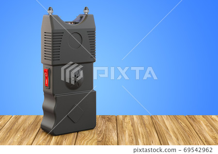 Stun Gun, electroshock weapon on the wooden table. 3D rendering Stun Gun, electroshock weapon on the wooden table. 3D rendering 69542962