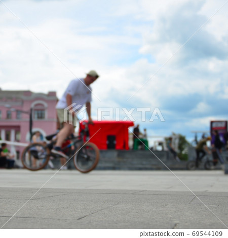 Defocused image of a lot of people with bmx bikes. Meeting of fa Defocused image of a lot of people with bmx bikes. Meeting of fa 69544109