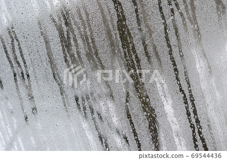 The texture of a misted glass with a lot of drops and condensati 69544436