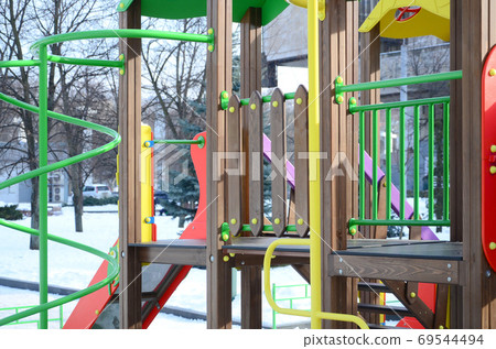 Fragment of a playground made of plastic and wood, painted in di 69544494