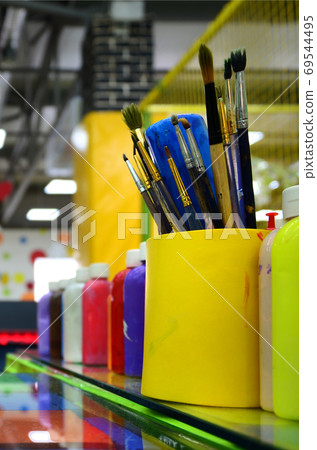 Art paint brushes in cup are located in the children's entertain 69544495